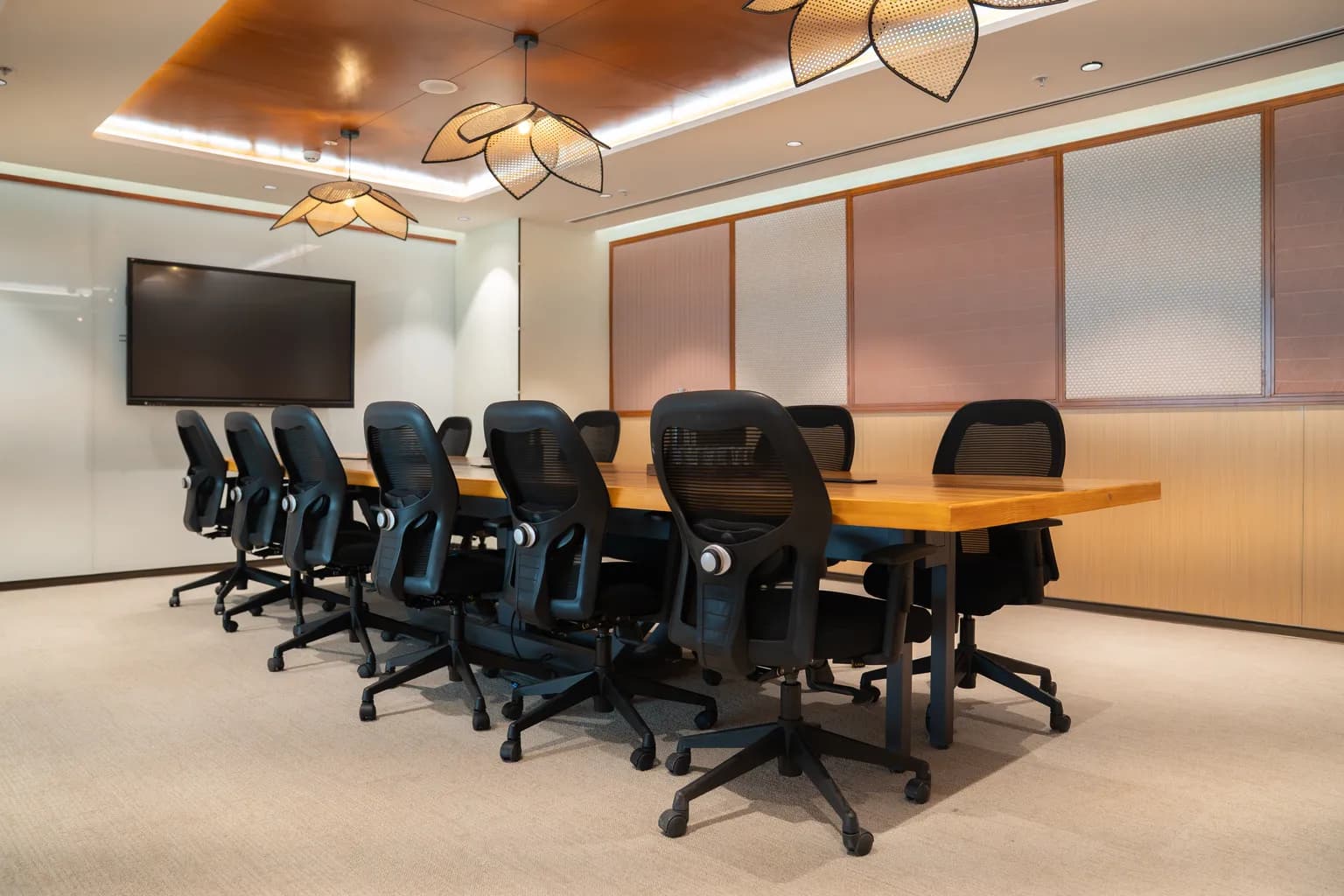 ClayWorks meeting room with conference table and display screen