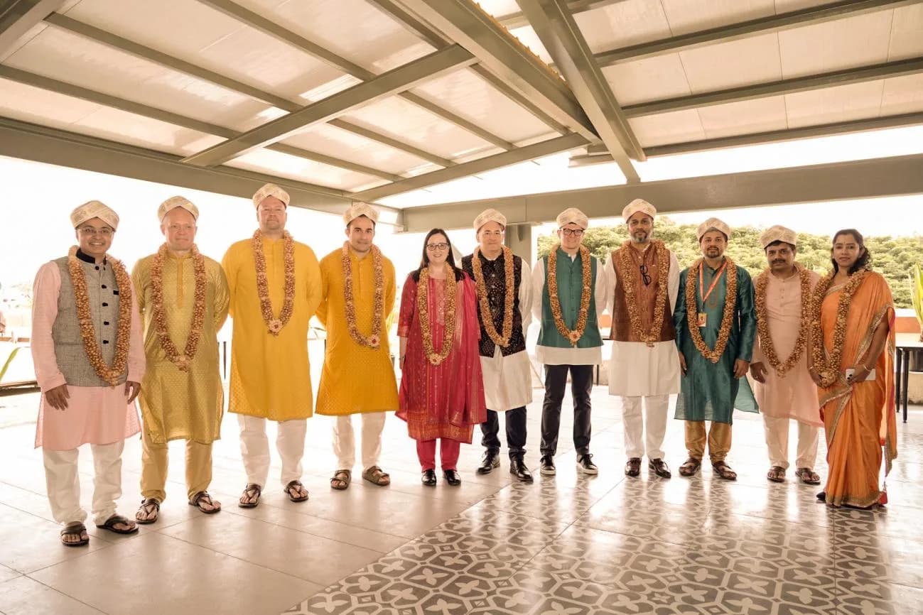 One Advanced's UK and India leadership in traditional dress with garlands and petas at the inauguration