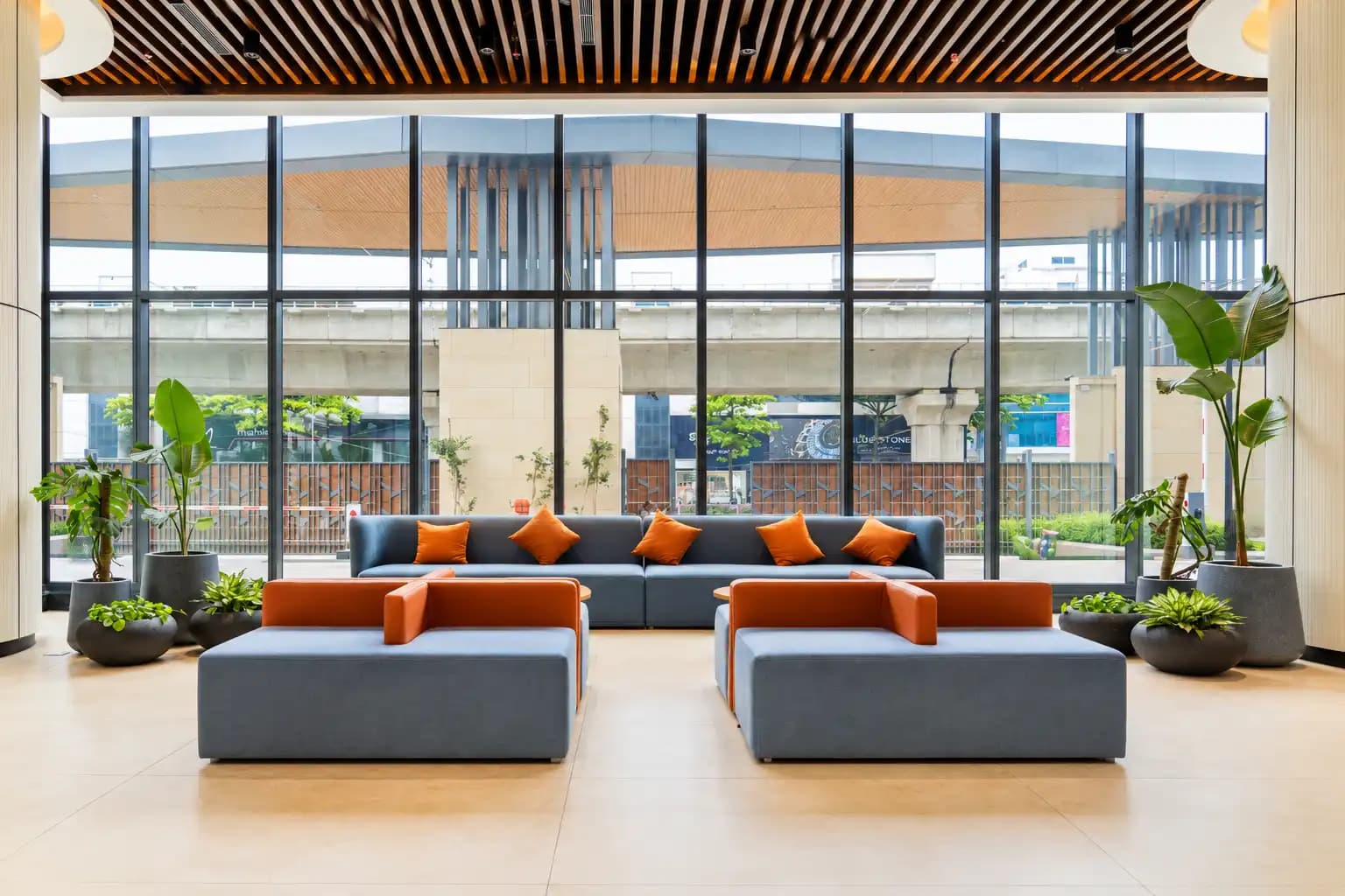 Lounge seating against a glass facade looking out to the metro line on Bannerghatta Road